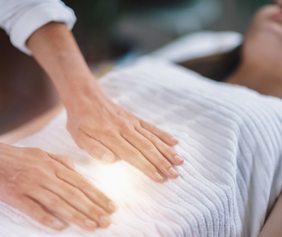 two hands touching the stomach of a woman